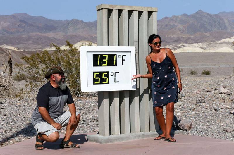 DEATH VALLEY NATIONAL PARK, CALIFORNIA - AUGUST 17: Visitors gather for a photo in front of an unofficial thermometer at Furnace Creek Visitor Center on August 17, 2020 in Death Valley National Park, California. The temperature reached 130 degrees at Death Valley National Park on August 16, hitting what may be the hottest temperature recorded on Earth since at least 1913, according to the National Weather Service. Park visitors have been warned, Travel prepared to survive.   Mario Tama/Getty Images/AFP

== FOR NEWSPAPERS, INTERNET, TELCOS & TELEVISION USE ONLY ==

