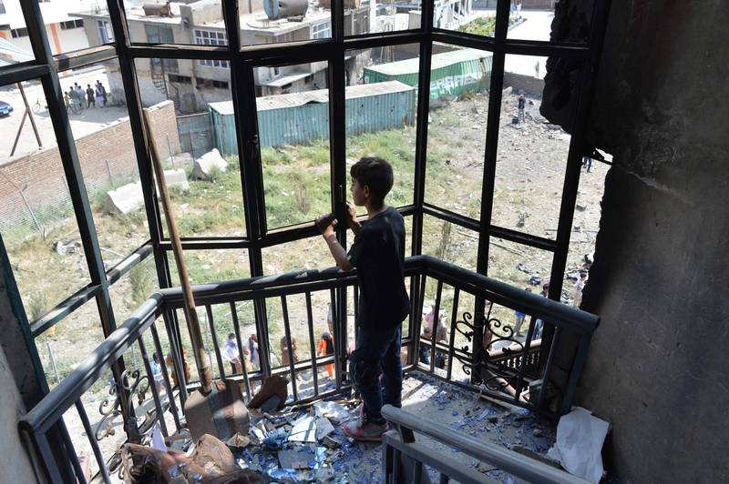 An Afghan boy looks on in a damaged house near the site of an attack in Kabul, a day after the deadly assault targeting a political campaign office. Deadly violence marred the start of Afghanistan's election season on the weekend, after President Ashraf Ghani insisted "peace is coming" to the war-torn nation.  AFP