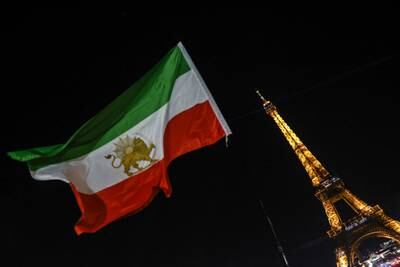 Iran's former flag flies next to the Eiffel Tower displaying the slogan #StopExecutionsInIran in support of the Iranian people, in Paris, France, 16 January 2023. EPA