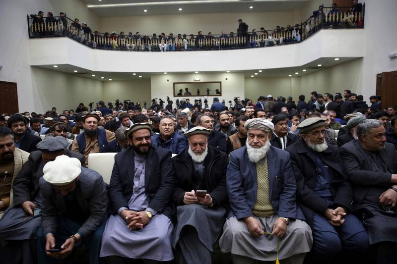 Party members wait for Afghan presidential candidate Abdullah Abdullah to speak at a party conference, in Kabu. AP Photo