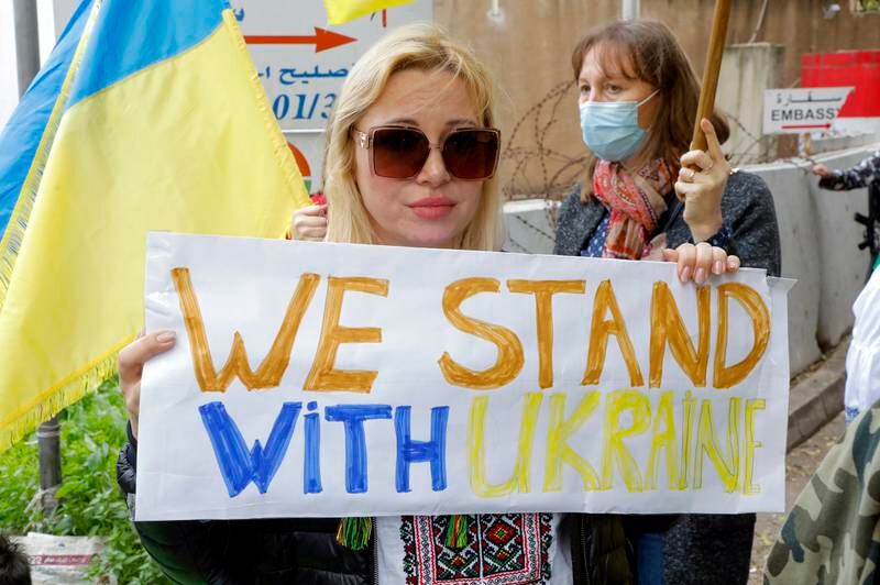 A Ukrainian woman carries a placard. EPA