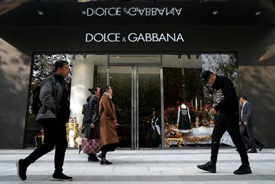 People walk past a Dolce & Gabbana store at a shopping complex in Shanghai, China November 22, 2018. REUTERS/Aly Song