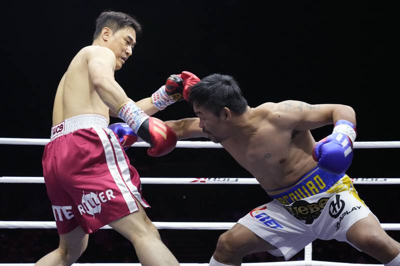 Manny Pacquiao throws a body shot at DK Yoo during the second round of their exhibition bout. AP