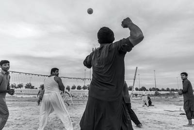 ABU DHABI, UNITED ARAB EMIRATES. 10 JANUARY 2020. Farm workers and laborers from Pakistan and India play an informal game of volleyball on a desolate patch of sand next to the Sheikh Mohammed Bin Rashid highway halfway between the Dubai and Abu Dhabi highway. (Photo: Antonie Robertson/The National) Journalist: STANDALONE. Section: Weekend.