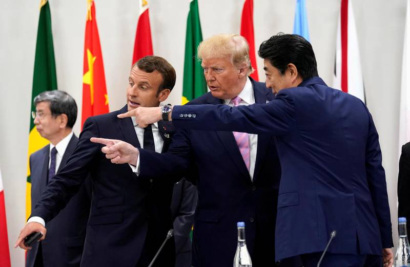 France's Macron, Trump and Abe gesture together during a meeting. Reuters