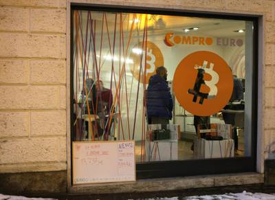 A picture shows the first Italian Bitcoin crypto currency shop "Bitcoin Compro Euro" (meaning I Buy Euro), on December 11, 2017 in Rovereto, northern Italy. Bitcoin surged past $18,000 after making its debut on a major global exchange but was trading lower on December 11, 2017, highlighting the volatility of the controversial digital currency that has some investors excited but others nervous. / AFP PHOTO / PIERRE TEYSSOT