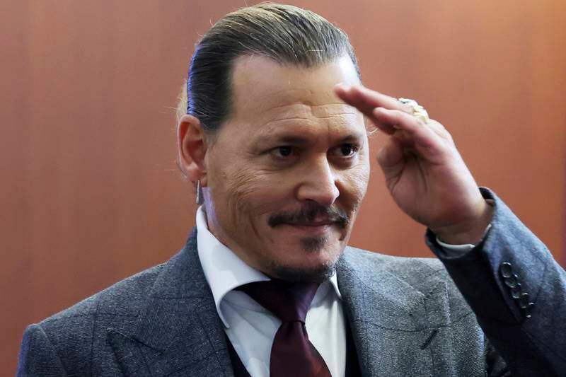 Depp gestures to his fans in the Virginia courtroom. AP