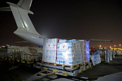 Workers and volunteers load a shipment of humanitarian aid to be sent to Afghanistan at Bahrain International Airport on Muharraq Island, near the capital Manama. AFP
