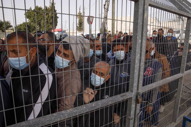 Palestinian labourers wait in line at a temporary vaccination centre at the Rachel's Tomb checkpoint crossing into Israel, in Bethlehem, West Bank. Bloomberg