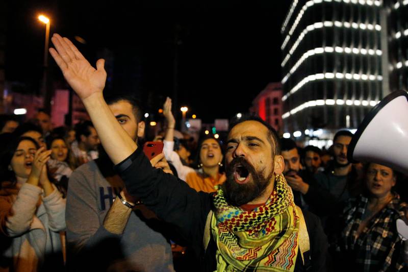 Protesters chant slogans as they block a highway during an anti-government protest in Beirut, Lebanon. AP Photo