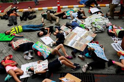 Environmental activist play dead as they participate in a Global Climate Strike in Bangkok. Reuters