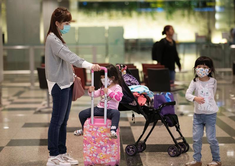 epa08181951 Travellers wearing masks are seen at the Changi Airport in Singapore, 31 January 2020. Singapore will close its borders to travellers from China, including foreigners who have been in the country for 14 days as they ram up measures to stop the spread of the coronavirus outbreak that originated from Wuhan. The coronavirus outbreak has infected almost 10,000 people worldwide with the death toll at 213.  EPA/HOW HWEE YOUNG