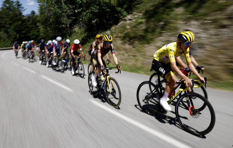 UAE Team Emirates' Tadej Pogacar, wearing the overall leader's yellow jersey, during Stage 11. Reuters