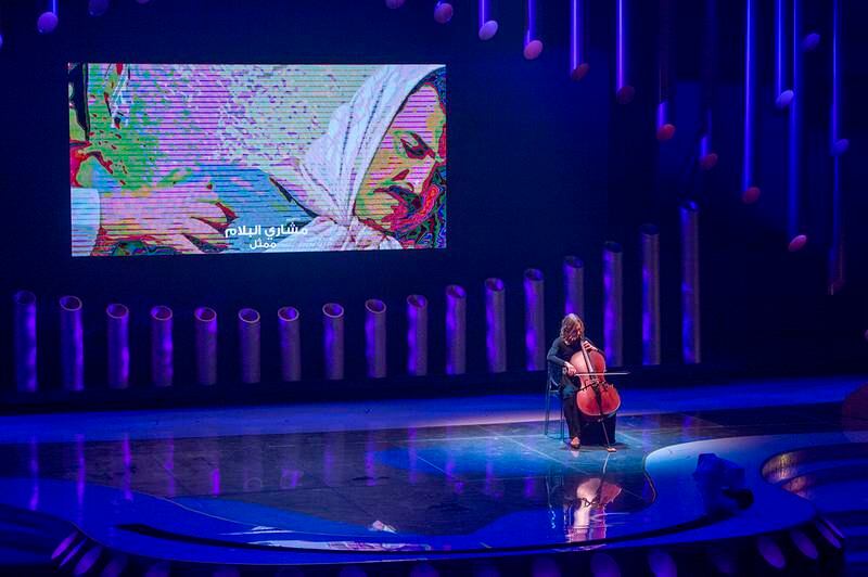 A musician performing a tribute in memory of Arab actors and singers who passed away in 2021.