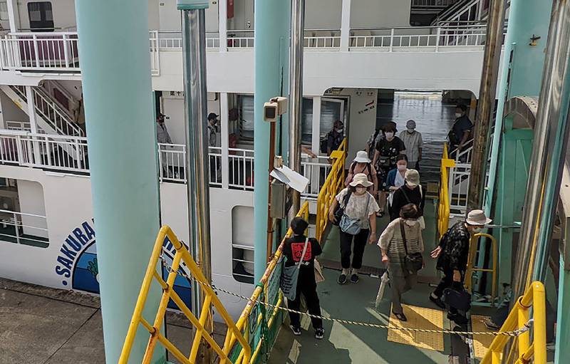 Evacuees disembark from a ferry at a port in Kagoshima City after the eruption.  AFP