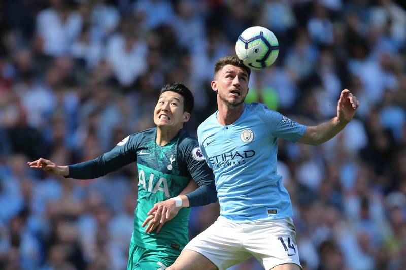Manchester City's Aymeric Laporte, right, vies for the ball against Tottenham Hotspur's Son Heung-min. EPA