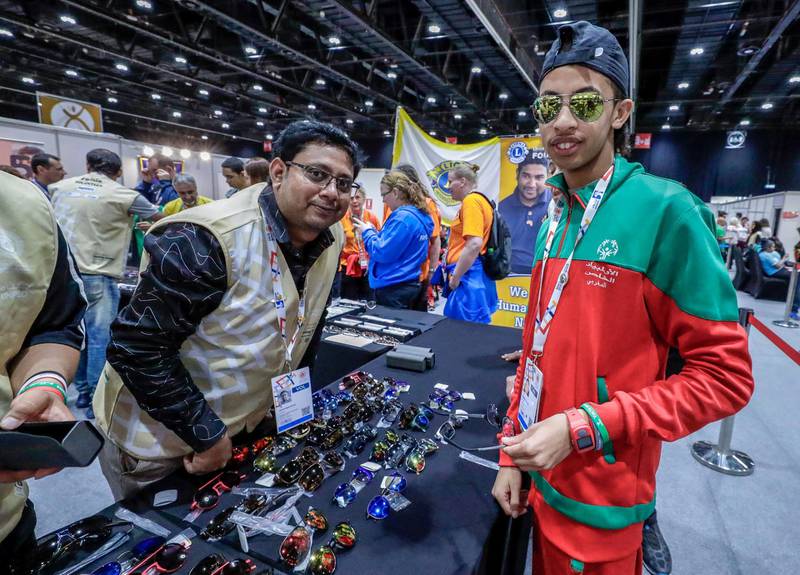 Abu Dhabi, March 17, 2019.  Special Olympics World Games Abu Dhabi 2019. At the Healthy Athletes area at ADNEC.  This is an area where the special athletes may get free medical check ups and enjoy other health activities. --  Bouyi Ilyas picks out a fre pair of sunglasses.Victor Besa/The National