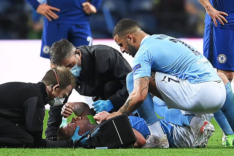 City midfielder Kevin de Bruyne receives treatment after being caught in the face by Antonio Rudiger's shoulder.