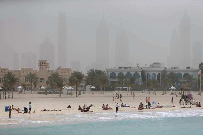 DUBAI, UAE. March 16, 2014- Beachgoers enjoy Jumeirah Open Beach amid a dusty skyline in Dubai, March 16, 2014. (Photo by: Sarah Dea/The National, Story by: STANDALONE, News)
