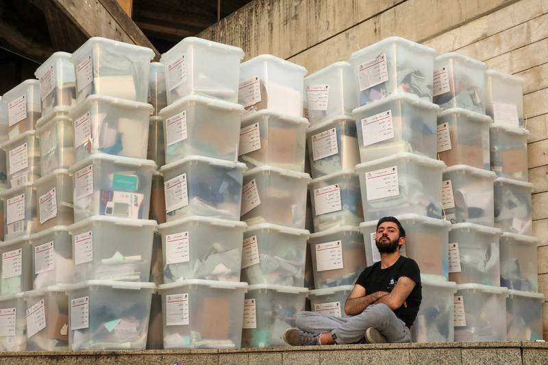 An electoral worker sits next to ballot boxes, at the Justice Palace, in Jdeideh. Reuters
