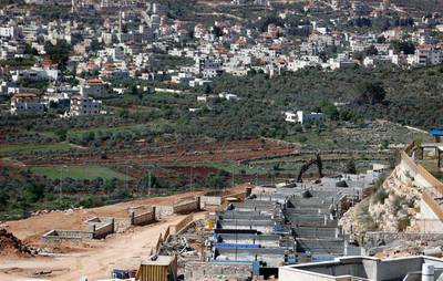 The Palestinian village of Turmus Ayya (background) faces houses under construction in the Jewish settlement of Shilo in the occupied West Bank between Ramallah and Nablus. The Israeli security cabinet gave its unanimous backing to the new settlement on March 30, 2017. Thomas Coex / Agence France-Presse 