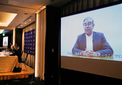 In this April 9, 2019, photo,  former Nissan chairman Carlos Ghosn, seen on a screen, speaks in a video during a press conference held by his lawyers in Tokyo. Ghosn, who was arrested in Japan on financial misconduct charges, gets his say in a video shown by his legal team. (AP Photo/Koji Sasahara)