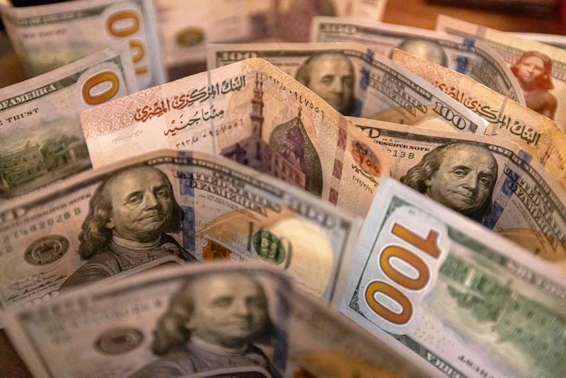 The Egyptian pound continues to slide against the US dollar, with analysts predicting further devaluation as Cairo seeks to meet a key requirement for an International Monetary Fund loan. AFP