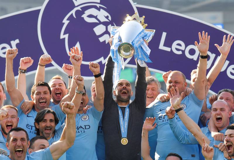 Manchester City manager Pep Guardiola lifts the Premier League trophy. Reuters
