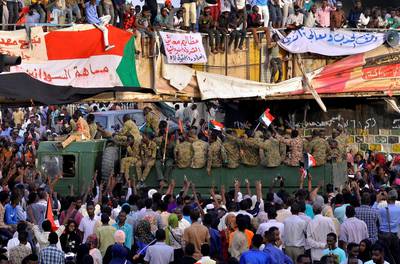 A Sudanese military truck passes through demonstrators attending a sit-in protest outside the Defence Ministry in Khartoum. Reuters