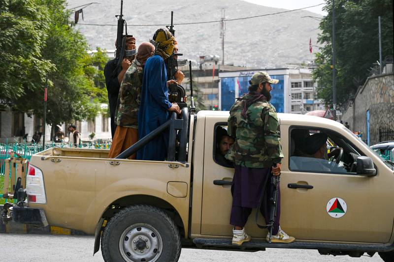 Taliban fighters in an Afghan government forces pickup patrol the streets of Kabul. AFP