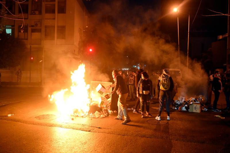 Anti-government protesters burn tyres and rubbish bins to block the main road leading to Hamra street during a rally against the power cuts the high cost of living and the low purchasing power of the Lebanese pound, in Beirut. EPA