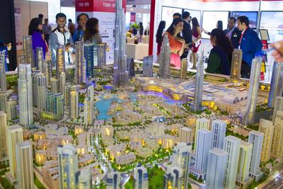 Above, visitors take a look at a mock up at the  Dubai Property Show at Mumbai. Subhash Sharma for The National