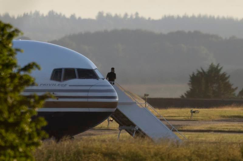 A man stands on the steps of the grounded Rwanda deportation flight EC-LZO Boeing 767 at Boscombe Down Air Base, in  Wiltshire, England. The flight taking asylum seekers from the UK to Rwanda was grounded at the last minute after intervention of the European Court of Human Rights. Getty Images