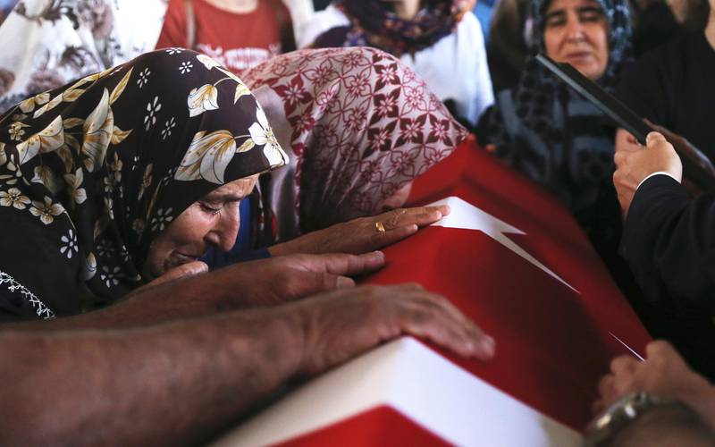 epa07724951 Relatives of Turkish diplomat Osman Kose cries on his coffin during his funeral ceremony in Ankara, Turkey, 18 July 2019. Turkish consulate employee  Osman Kose was killed when gunmen opened fire at the restaurant where Turkish diplomats were present on 17 July in Erbil, Iraq.  EPA/STR