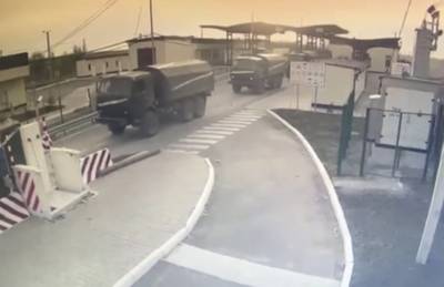 The Border Service of Ukraine released CCTV footage purporting to show Russian military vehicles passing a checkpoint to drive into Crimea. AP
