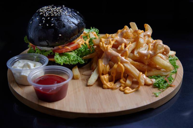 Food on the menu represents various countries' street food. Pictured is the black burger, which is meant to represent Tokyo, Japan