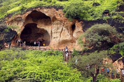 Tourists visit a cave at Ain Razat, a water spring in Salalah, Dhofar province, Oman August 20, 2016. Picture taken August 20, 2016. REUTERS/Ahmed Jadallah