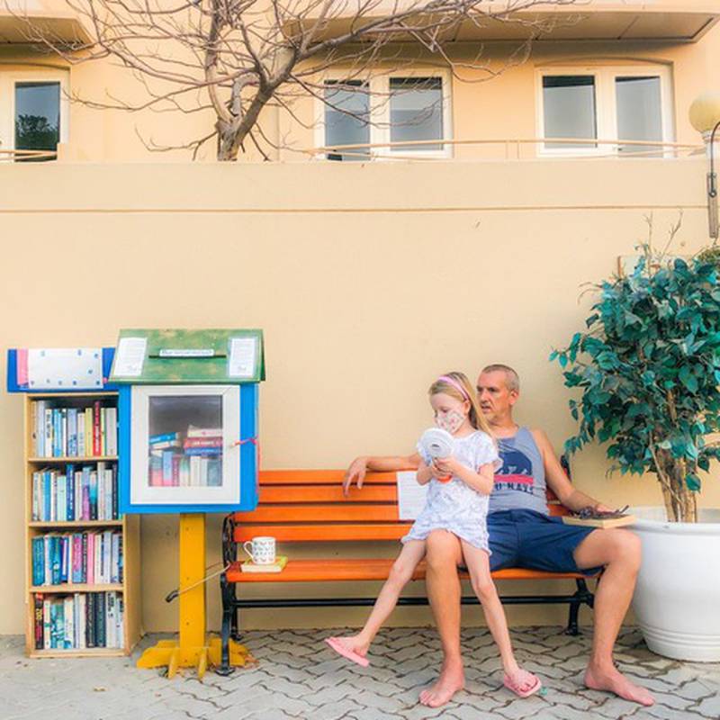 Kelly Harvarde's husband Alex Jeffries and daughter Aya next to their Little Free Library outside their Dubai home. Photo: Kelly Harvarde