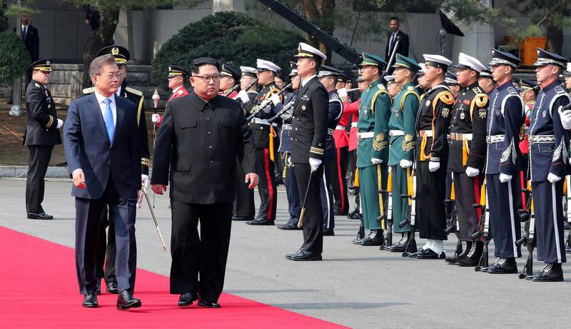 The leaders inspect a guard of honour. Korea Summit Press Pool via AP