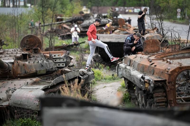 People inspect destroyed Russian tanks and armoured vehicles in Irpin, Ukraine. Getty Images