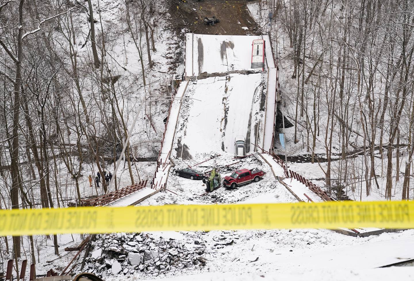 Vehicles are seen on the remains of a bridge that collapsed in Pittsburgh, Pennsylvania, US , January 28, 2022. Reuters