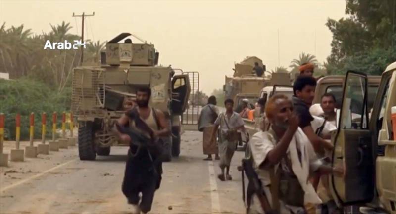 This still image taken from video provided by Arab 24 shows Saudi-led forces gathering to retake the international airport of Yemen's rebel-held port city of Hodeida from the Shiite Houthi rebels Saturday, June 16, 2018.  With battles raging at the southern side of al-Hodeida International Airport, the military of Yemen's exiled government said it had entirely seized the facility, and that engineers were working to clear mines from nearby areas just south of the city of some 600,000 people on the Red Sea.  (Arab 24 via AP)