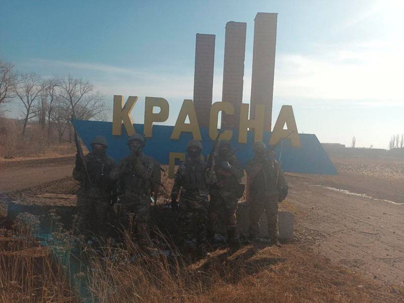 A group of men believed to be Wagner Group fighters pose for a picture in the village of Krasna Hora, near the embattled city of Bakhmut, Ukraine. Reuters