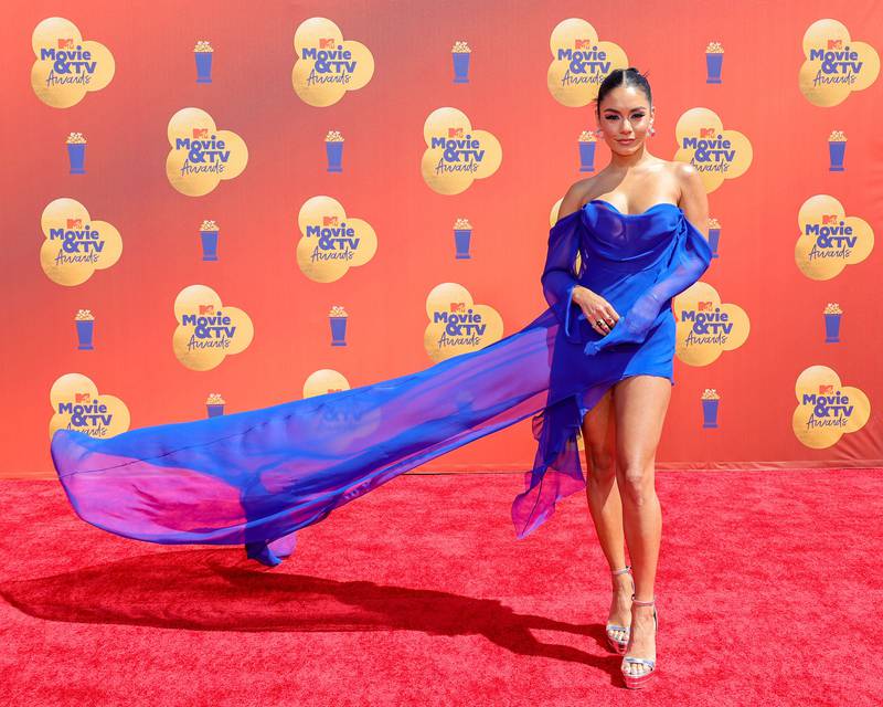 Vanessa Hudgens in a blue mini-dress with a statement train. AFP