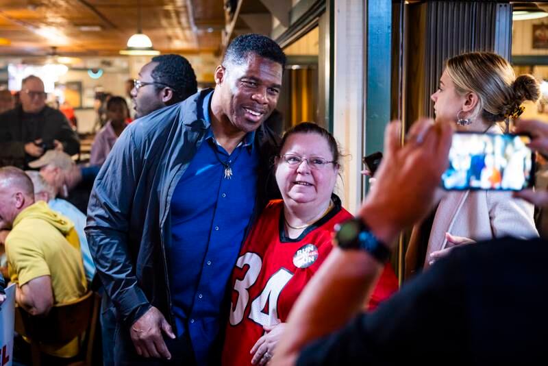 Mr Walker poses with a patron and University of Georgia American football fan at Curt's Restaurant in Flowery Branch. EPA