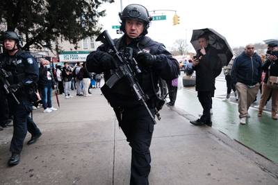 Heavily armed police at the scene of the shooting in Brooklyn's Sunset Park neighbourhood.   AFP