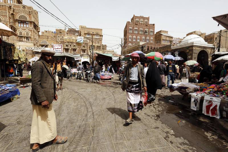 epa06566804 Yemenis walk through a market in the old quarter of Sana'a, Yemen, 26 February 2018. According to reports, the UN Security Council was considering two draft resolutions on Yemen after Russia put forward a rival text aimed at blocking action against Iran over missiles sent to the country's Houthi rebels. The council is set to vote 26 February on renewing sanctions on Yemen for a year.  EPA/YAHYA ARHAB