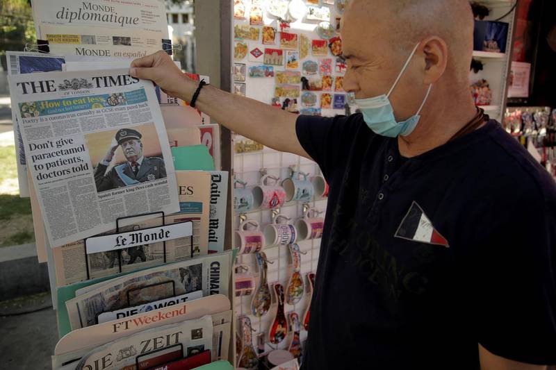 A man looks at newspaper headlines with news about Spain's former king Juan Carlos I, in Madrid, Spain August 4, 2020. REUTERS