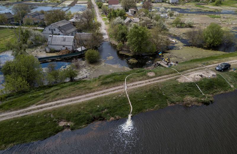 Water gushes from a pump station after Ukrainian troops opened a dam to flood a residential area in Demydiv, to stop the advance of Russian forces towards the capital Kyiv. Reuters