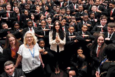 LONDON, ENGLAND - MARCH 06: Meghan, Duchess of Sussex poses with school children making the 'Equality' sign following a school assembly during a visit to Robert Clack School in Dagenham to attend a special assembly ahead of International Women‚Äôs Day (IWD) held on Sunday 8th March, on March 6, 2020 in London, England.   (Photo by Ben Stansall-WPA Pool/Getty Images)